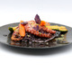 Poulpe grillé persillé riz noir